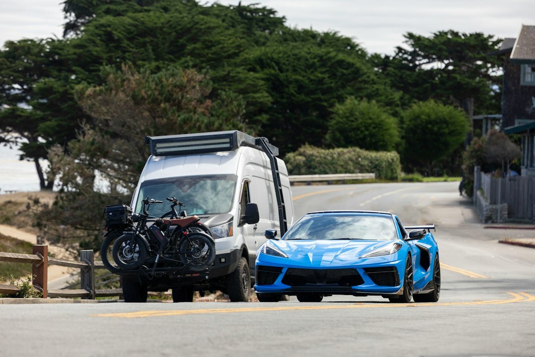 Exotic sports car driving on a coastal road near Punta del Este at sunset