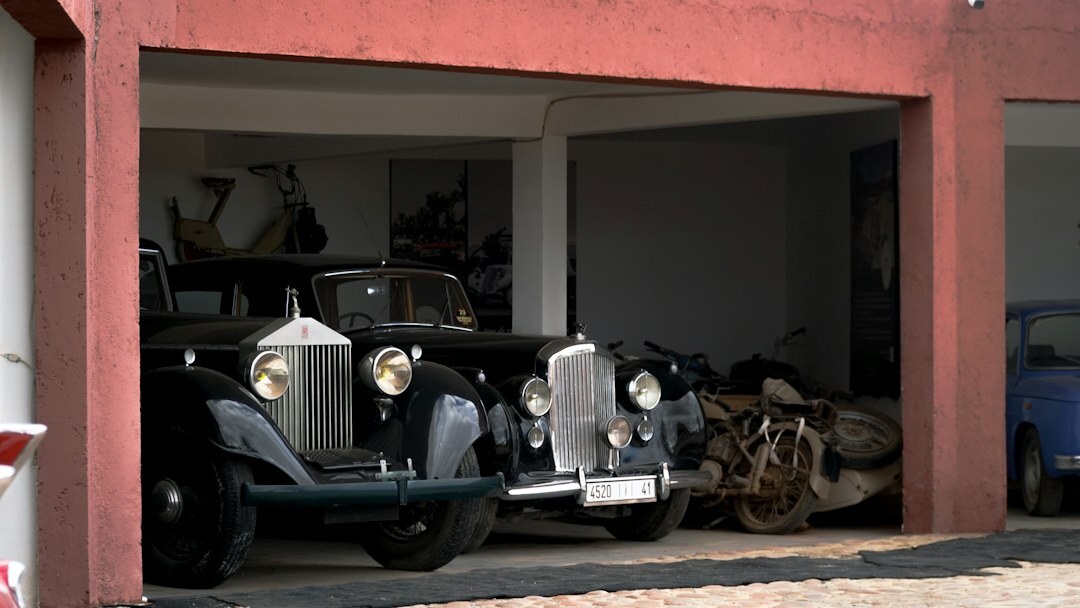 Dim historic garage filled with restored vintage automobiles
