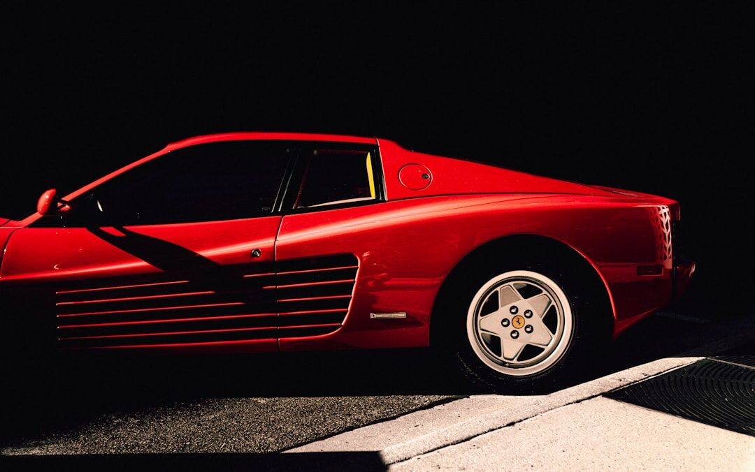 Vintage Ferrari sports car parked in front of a colonial building in Uruguay