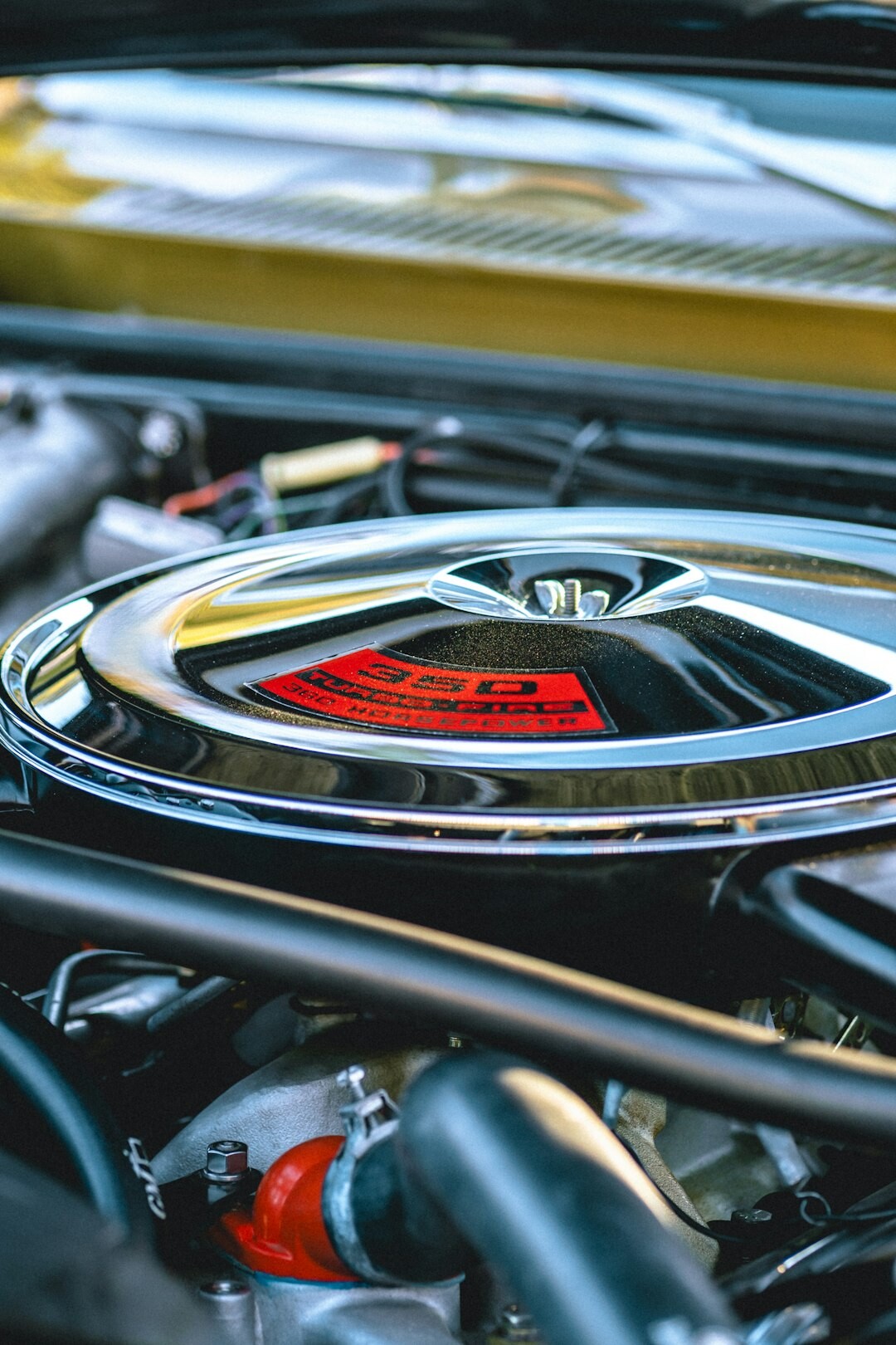 Close-up of a vintage car engine bay with polished chrome details